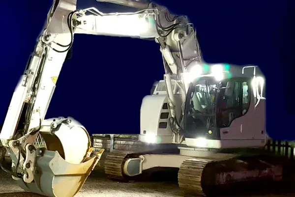 Engin de chantier éclairé lors d'une intervention de nuit sur site